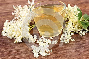 Fresh healthy juice and elderberry flowers on rustic board