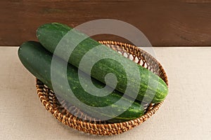 Fresh and healthy organic cucumbers served on bamboo plate