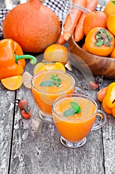 Fresh healthy pulpy cocktail with orange fruits and berries and