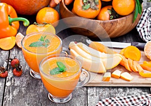 Fresh healthy pulpy cocktail with orange fruits and berries and