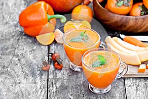 Fresh healthy pulpy cocktail with orange fruits and berries and