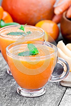 Fresh healthy pulpy cocktail with orange fruits and berries and