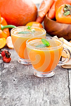 Fresh healthy pulpy cocktail with orange fruits and berries and