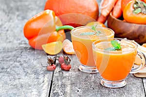 Fresh healthy pulpy cocktail with orange fruits and berries and photo