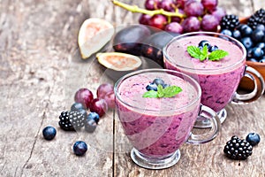 Fresh healthy pulpy cocktail with purple fruits and berries photo