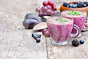 Fresh healthy pulpy cocktail with purple fruits and berries