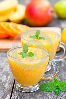 Fresh healthy pulpy juice with orange fruits and vegetables