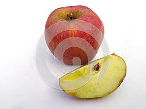 A fresh healthy red apple with a bite of apple  on white background