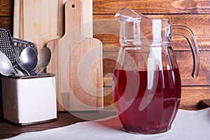 Fresh and healthy red Fruit juice drink in a glass jug on the w