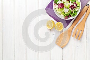 Fresh healthy salad and kitchen utensils