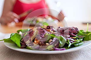 Fresh and healthy vegetable salad with chunks of grilled halloumi goat cheese on top