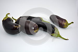 Fresh and healthy vegetables from breast, blue, purple eggplants located on a white background.