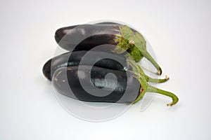 Fresh and healthy vegetables from breast, blue, purple eggplants located on a white background.