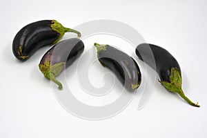 Fresh and healthy vegetables from breast, blue, purple eggplants located on a white background.