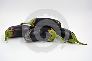 Fresh and healthy vegetables from breast, blue, purple eggplants located on a white background.