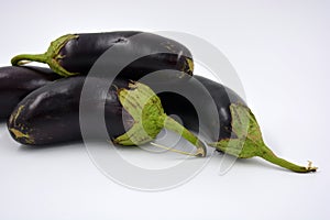 Fresh and healthy vegetables from breast, blue, purple eggplants located on a white background.