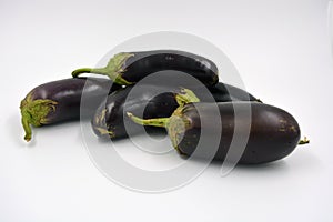 Fresh and healthy vegetables from breast, blue, purple eggplants located on a white background.