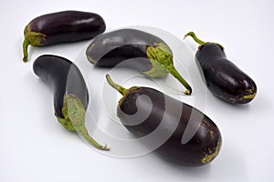 Fresh and healthy vegetables from breast, blue, purple eggplants located on a white background.