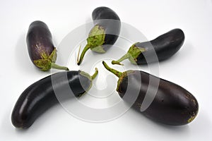 Fresh and healthy vegetables from breast, blue, purple eggplants located on a white background.