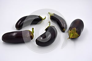Fresh and healthy vegetables from breast, blue, purple eggplants located on a white background.