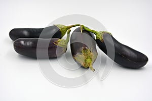 Fresh and healthy vegetables from breast, blue, purple eggplants located on a white background.