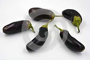 Fresh and healthy vegetables from breast, blue, purple eggplants located on a white background.