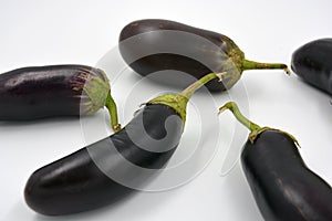 Fresh and healthy vegetables from breast, blue, purple eggplants located on a white background.