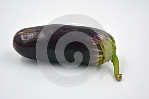 Fresh and healthy vegetables from breast, blue, purple eggplants located on a white background.