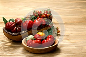 Fresh heirloom tomatoes on wooden table