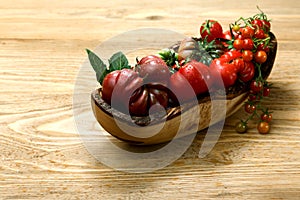 Fresh heirloom tomatoes on wooden table