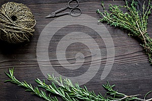 Fresh herb frame on dark wooden background top view