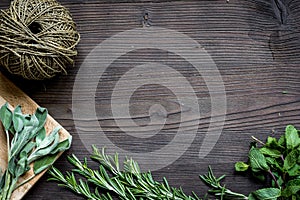 Fresh herb frame on dark wooden background top view