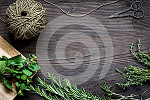 Fresh herb frame on dark wooden background top view