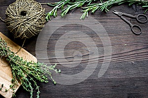 Fresh herb frame on dark wooden background top view