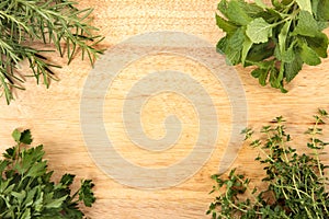 Fresh herbs on the corner of chopping board