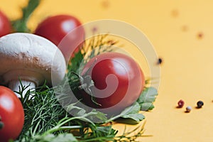 Fresh herbs dill, parsley,mushroom, tomato  at yellow paper background. top view. Copy space