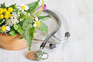 Fresh herbs and stethoscope alternative medicine concept