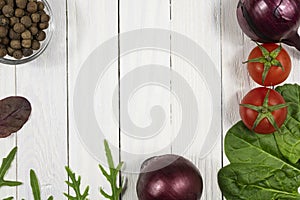 Fresh herbs and vegetables and spices on a white wooden background. Top view