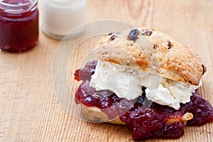 Fresh home baked scone with jam and clotted cream photo