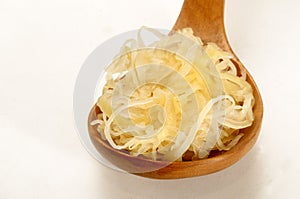 Fresh home made sauerkraut on a wooden spoon