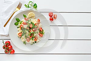 Fresh home-made tabouli, or tabbouleh salad, top view on white wooden background with copy space