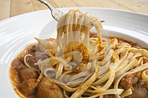 Fresh homecook spaghetti on wooden table