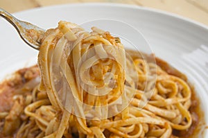 Fresh homecook spaghetti on wooden table