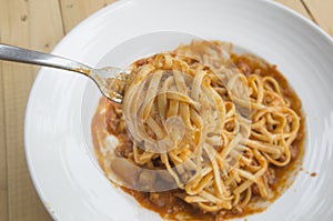 Fresh homecook spaghetti on wooden table