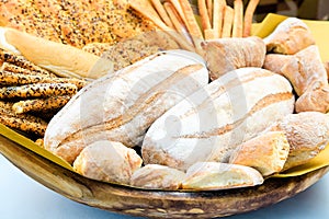Fresh homemade bread composition in basket. Various types of wheat bakery in Sunday market. Nutrition exhibition
