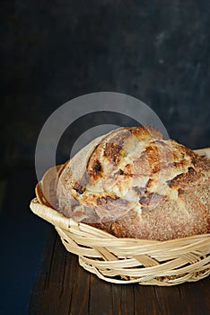 Fresh homemade bread from whole wheat and rye flour with flax seeds, pumpkin and oat flakes on a brown background. Crisp.