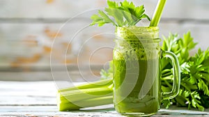 Fresh homemade celery juice in a glass jar, with celery stalks. Healthy eating concept, light wooden background. Perfect