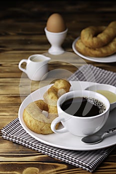 Fresh homemade Chinese donut with black coffee on vintage wooden table. Freshness breakfast with boiled egg for healthy and nutrit