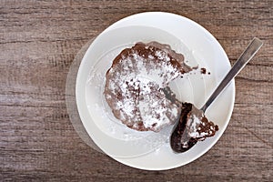 Fresh homemade chocolate cake on white plate. Top view.