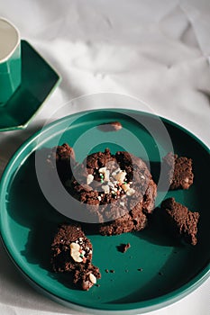 Fresh homemade chocolate chip cookies on green plate. Sweet breakfast. Stack of traditional chip cookies with chocolate chunks.